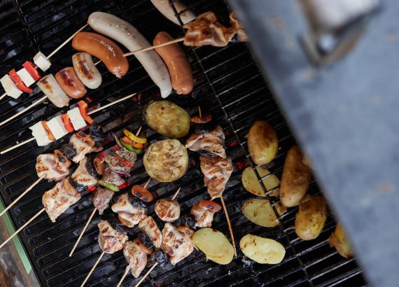 Verschiedene Grilladen liegen auf einem Grill.